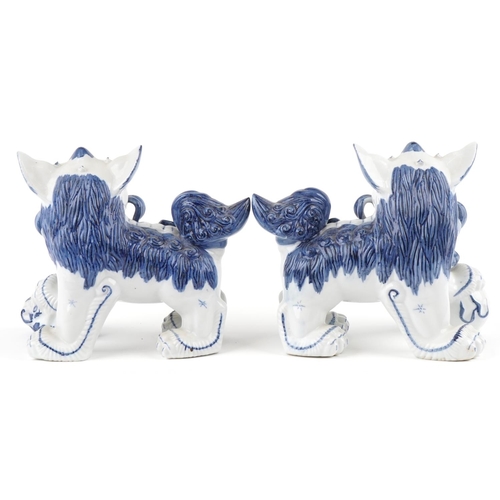 1605 - A pair of Chinese blue and white porcelain Foo dogs, late 20th century, 21cm high x 27cm wide.