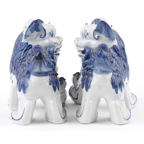 1605 - A pair of Chinese blue and white porcelain Foo dogs, late 20th century, 21cm high x 27cm wide.