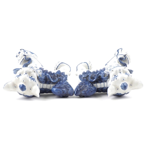 1605 - A pair of Chinese blue and white porcelain Foo dogs, late 20th century, 21cm high x 27cm wide.