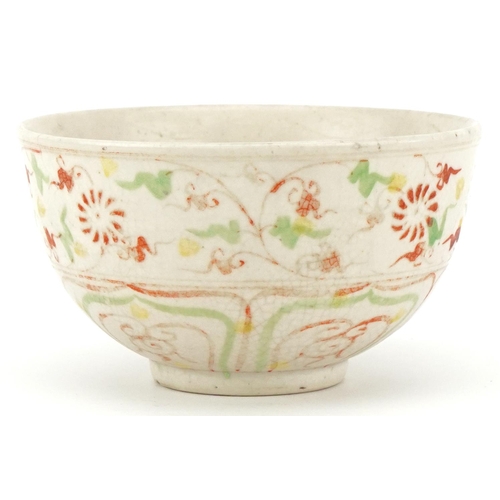 512 - A Chinese porcelain bowl hand painted in iron red and green with stylized motifs, 12cm in diameter.