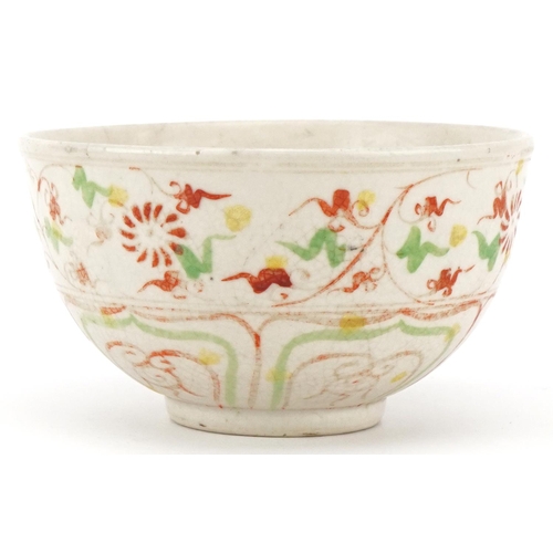 512 - A Chinese porcelain bowl hand painted in iron red and green with stylized motifs, 12cm in diameter.