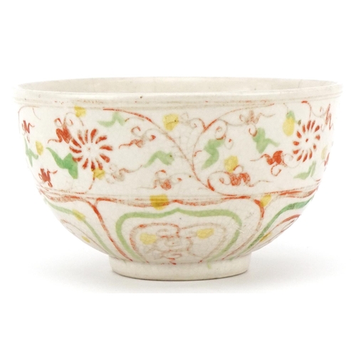512 - A Chinese porcelain bowl hand painted in iron red and green with stylized motifs, 12cm in diameter.