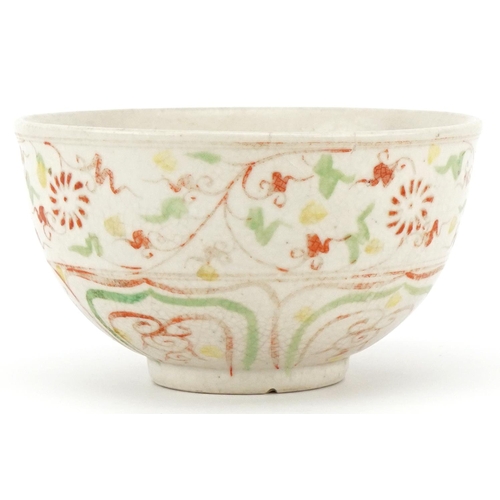 512 - A Chinese porcelain bowl hand painted in iron red and green with stylized motifs, 12cm in diameter.