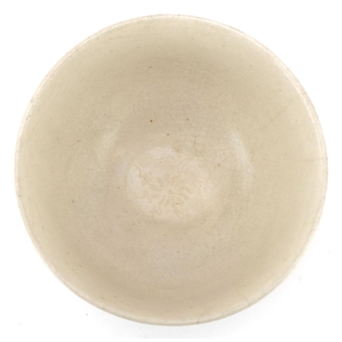 512 - A Chinese porcelain bowl hand painted in iron red and green with stylized motifs, 12cm in diameter.