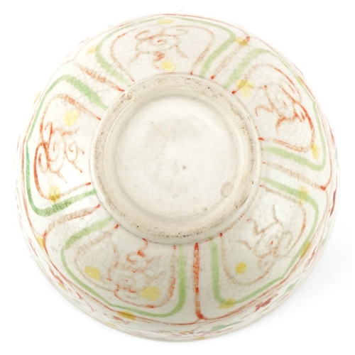 512 - A Chinese porcelain bowl hand painted in iron red and green with stylized motifs, 12cm in diameter.