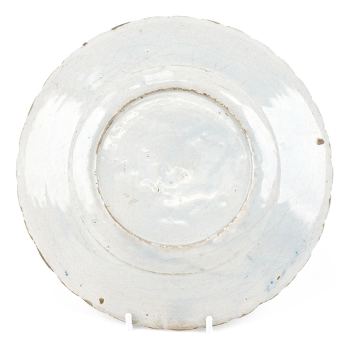 114 - A 19th century tin glazed blue and white plate, 22.5cm in diameter.