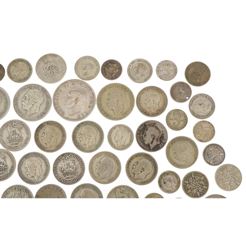 1248 - A quantity of British pre 1947 silver coinage to include threepences, sixpences, shillings, florins ... 