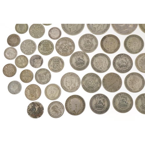 1248 - A quantity of British pre 1947 silver coinage to include threepences, sixpences, shillings, florins ... 