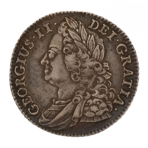 A George II 1743 silver shilling with roses in the angles, diameter 25mm, 6g.