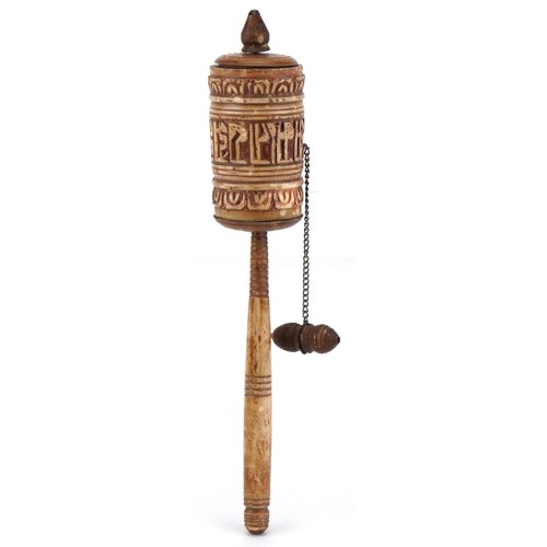 1592 - A Middle Eastern carved yak bone prayer wheel, 19cm in length.