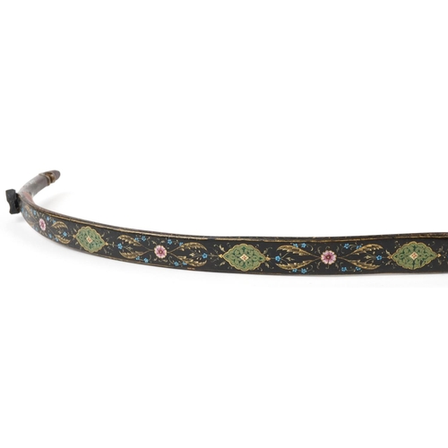 384 - A Turkish Ottoman fighting bow hand painted and gilded with flowers, 88cm in length.