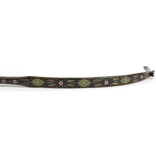 384 - A Turkish Ottoman fighting bow hand painted and gilded with flowers, 88cm in length.