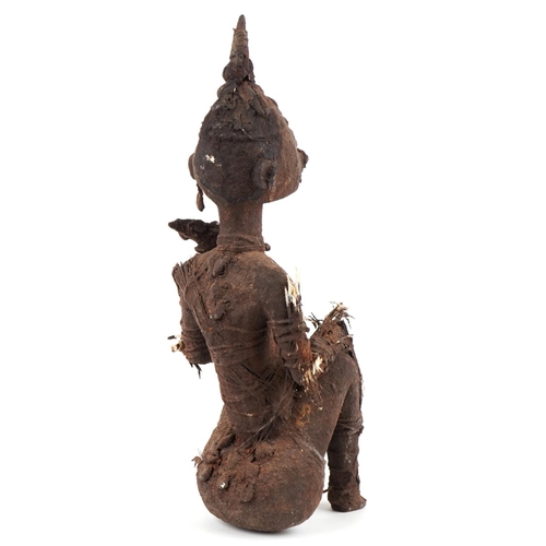 478 - An African tribal carved softwood seated figure, possibly Benin, circa 1900, bound with string and f... 