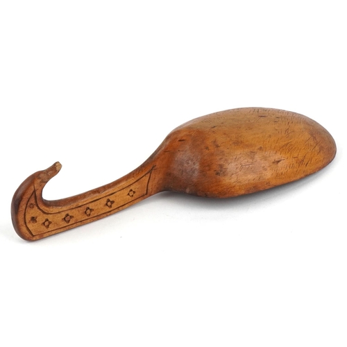 479 - An African carved softwood serving spoon, early 20th century, 24cm in length.