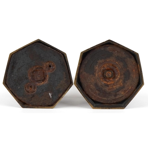 9 - A pair of 19th century bronze ecclesiastical candle holders, each with engraved decoration, raised o... 