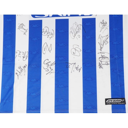 1411 - Two signed Brighton & Hove Albion 2000-2021 home football shirts, one XL, the other S.