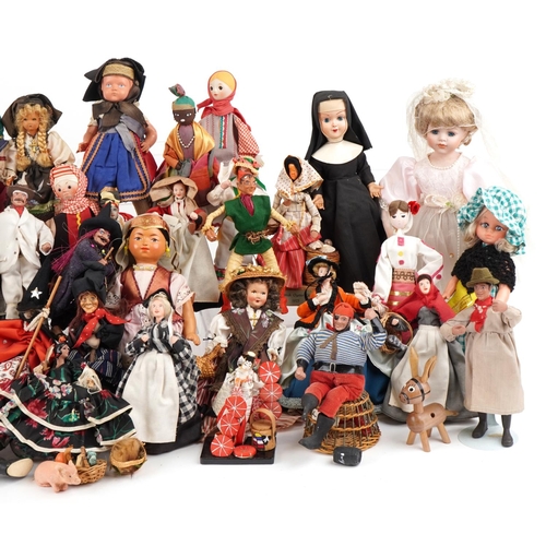 1163 - An extensive collection of souvenir dolls, clowns and animals from around the world, the largest 44c... 