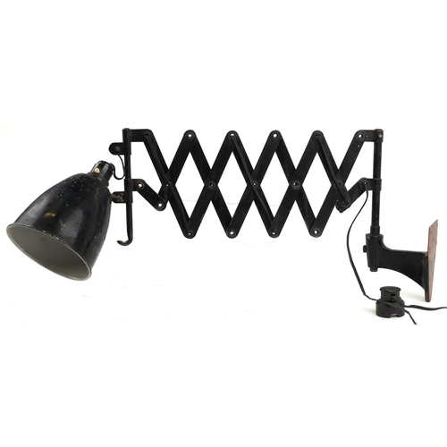 450 - A vintage industrial scissor action wall mounted adjustable lamp, 80cm in length extended.