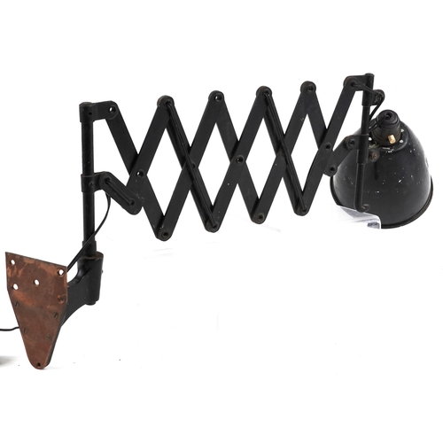 450 - A vintage industrial scissor action wall mounted adjustable lamp, 80cm in length extended.