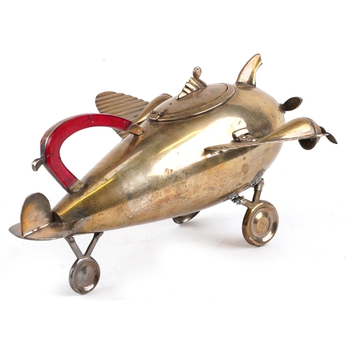 158 - An Art Deco silver plated teapot in the form of an aeroplane, 28cm in length.