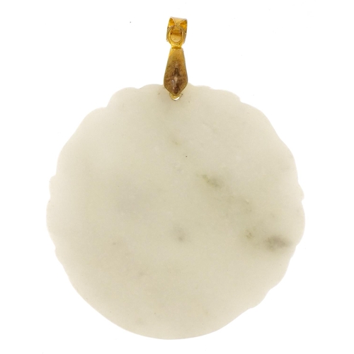 518 - A Chinese white carved jade circular pendant, 20th century, 5cm in diameter.