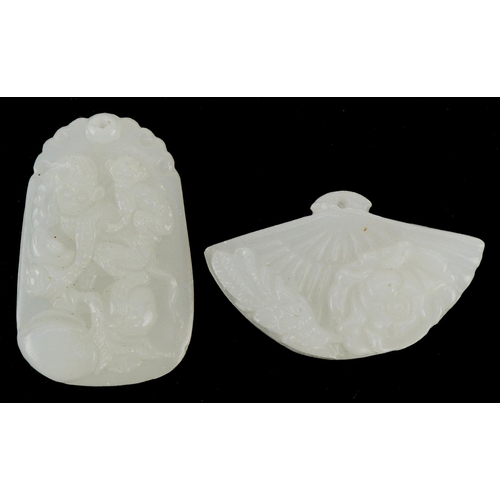 519 - A Chinese carved white jade pendant, 20th century, carved with two monkeys, 5cm high, together with ... 