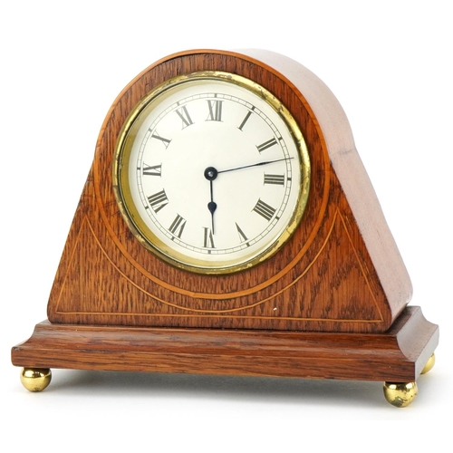 206 - A 20th century French oak cased mantle clock having enamelled dial with Roman numerals, 20th wide.