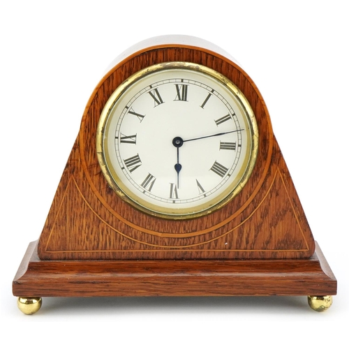 206 - A 20th century French oak cased mantle clock having enamelled dial with Roman numerals, 20th wide.