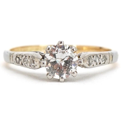 3024 - An 18ct gold and platinum diamond solitaire ring with diamond set shoulders, the solitaire diamond a... 