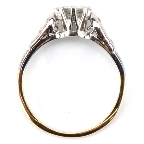 3024 - An 18ct gold and platinum diamond solitaire ring with diamond set shoulders, the solitaire diamond a... 