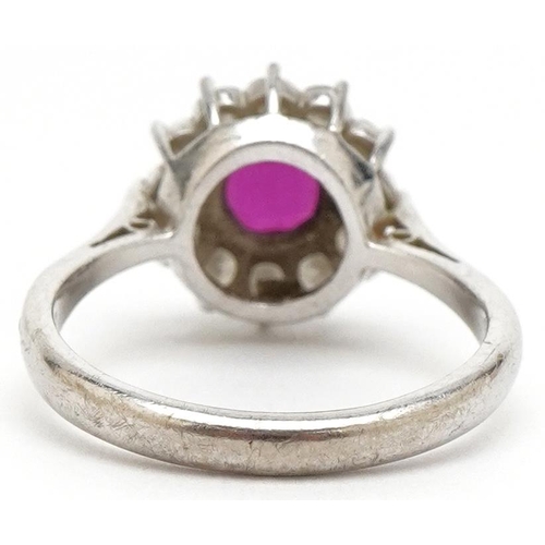 3074 - An 18ct white gold ruby and diamond flower head ring, the ruby approximately 6.15mm in diameter x 2.... 