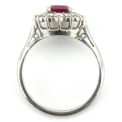 3074 - An 18ct white gold ruby and diamond flower head ring, the ruby approximately 6.15mm in diameter x 2.... 