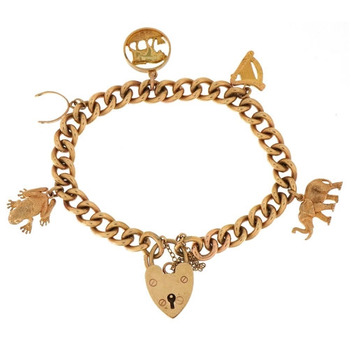 3007 - A heavy 9ct gold charm bracelet with five 9ct gold charms and love heart shaped padlock including el... 