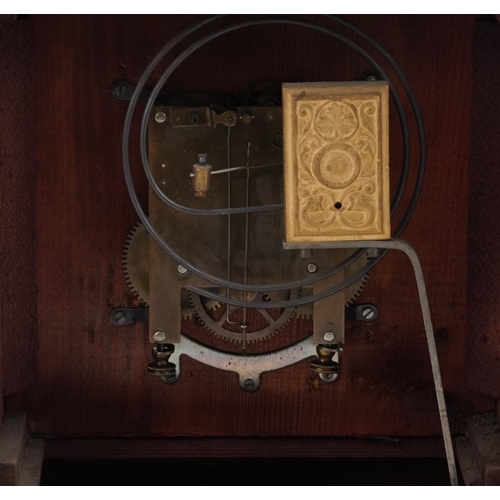 201 - A Victorian walnut cased mantle clock, with silvered dial, striking on a gong, raised on plinth brac... 