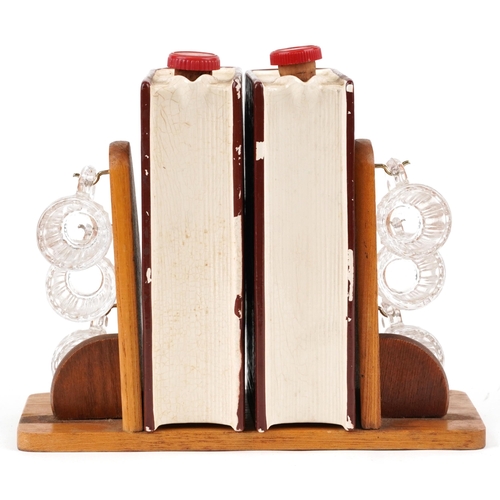 1648 - Two mid 20th century West German book decanters together with six shot glasses on an oak stand, 20cm... 