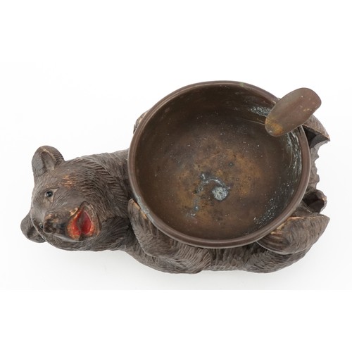 66 - An early 20th century Swiss Black Forest carved bear ashtray, 15cm in length.