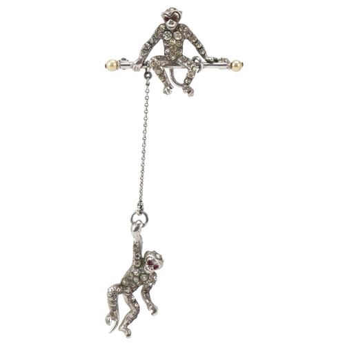 3012 - An antique silver brooch in the form of two monkeys set with clear paste and pink stones, 8cm high, ... 