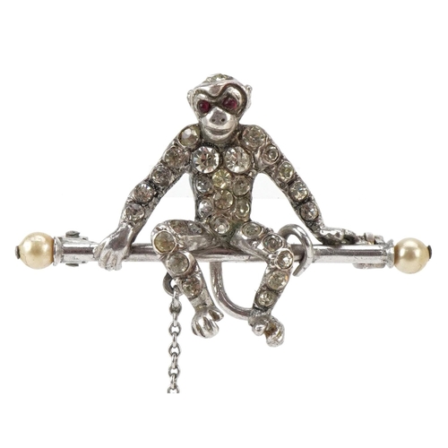 3012 - An antique silver brooch in the form of two monkeys set with clear paste and pink stones, 8cm high, ... 