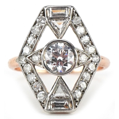 An Art Deco unmarked gold diamond cocktail ring set with round brilliant cut and baguette cut diamonds, the central diamond approximately 0.75 carat, the ring head 18.0mm x 14.0mm, size M/N, 3.0g.