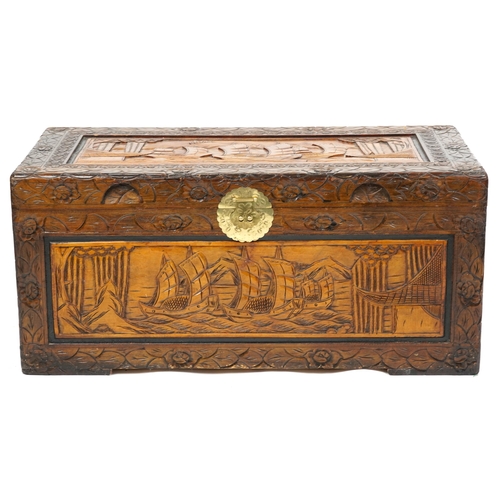 2106 - A Chinese carved camphor wood trunk, mid 20th century, profusely carved, the top and side panels dec... 