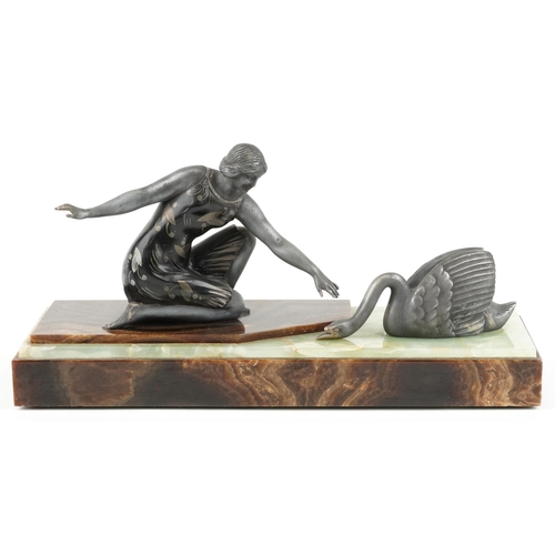 229 - An Art Deco spelter figure group of a lady and a swan circa 1930, raised on an onyx and marble plint... 