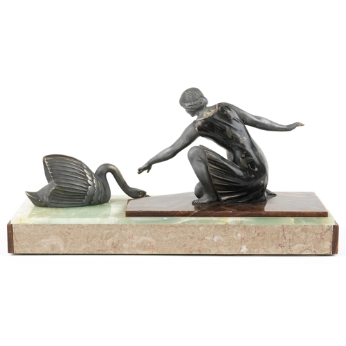229 - An Art Deco spelter figure group of a lady and a swan circa 1930, raised on an onyx and marble plint... 