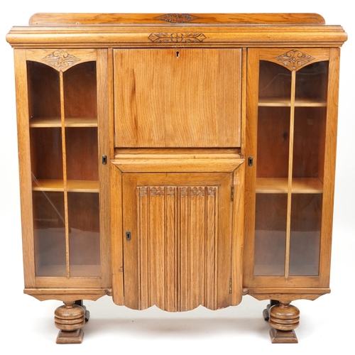 2175 - A George V oak bureau bookcase, the fall front flanked by glazed doors, 124cm H x 120cm W x 36cm D.