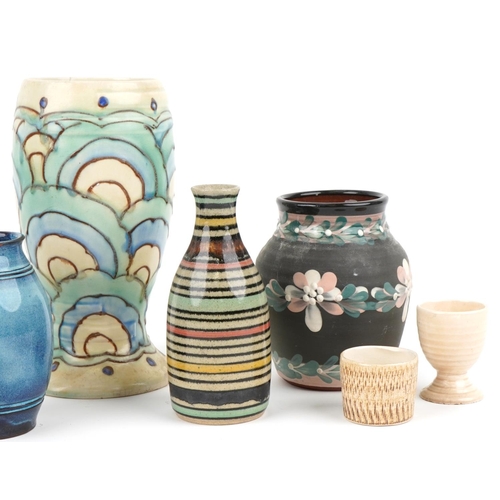 2558 - A small group of mixed pottery items including three vases, two handled jug, candlestick and two egg... 