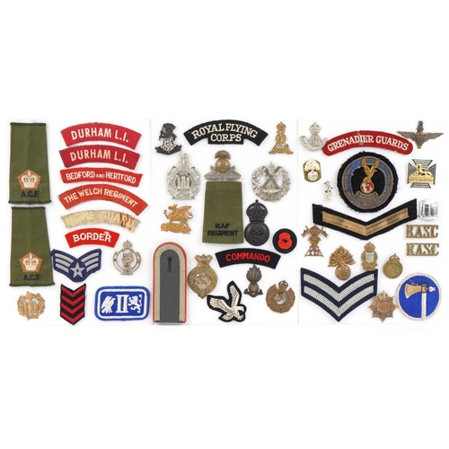 1488 - A collection of military interest cap badges and cloth patches including Royal Flying Corps, The Buf... 