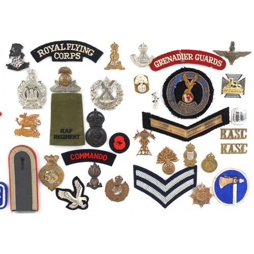 1488 - A collection of military interest cap badges and cloth patches including Royal Flying Corps, The Buf... 