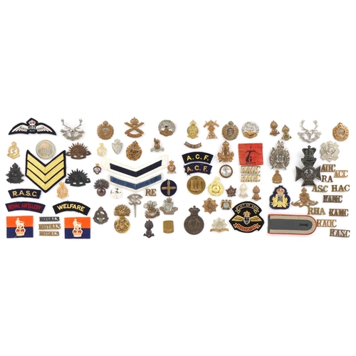 1486 - A group of military interest cap badges and cloth patches including The King's Royal Rifle Corps, Ro... 