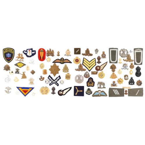 1487 - A group of military interest cap badges and cloth patches including Royal Engineers, Royal Flying Co... 