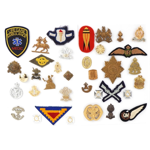 1487 - A group of military interest cap badges and cloth patches including Royal Engineers, Royal Flying Co... 