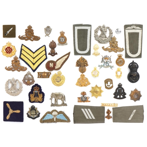 1487 - A group of military interest cap badges and cloth patches including Royal Engineers, Royal Flying Co... 